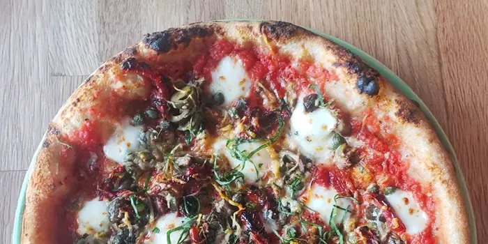 OG tomato sauce, chili flake, olives, capers, pomodoraccio tomatoes, fresh mozzarella, basil