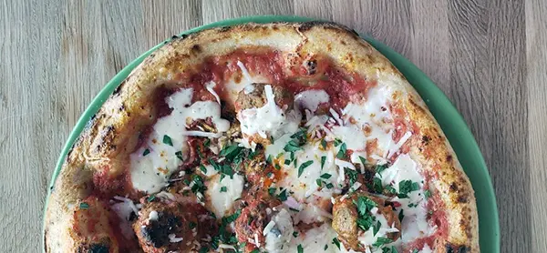 Organic tomato sauce, Calabrian chili, fresh mozzarella, parmesan fonduta, oregano.