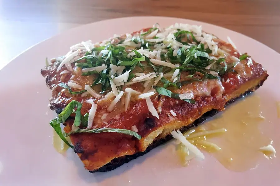 Focaccia with caramelized onion tomato sauce, caciocavallo, pecorino